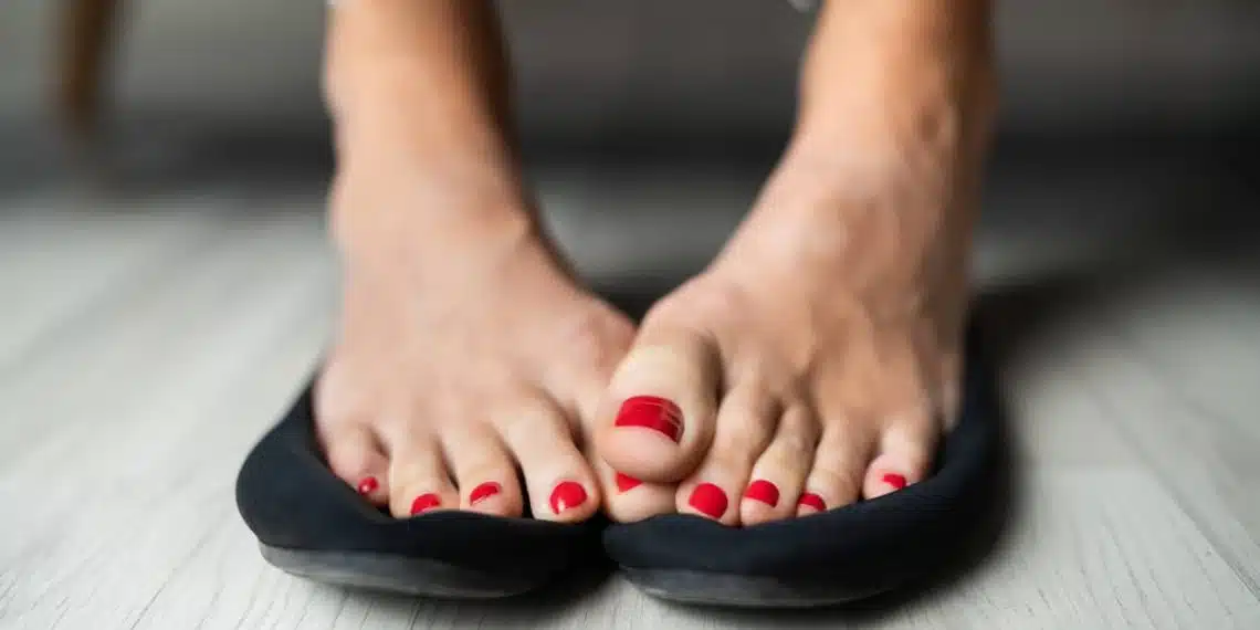 Close-up Of A Woman Sweaty Feet On Shoes On Hardwood Floor