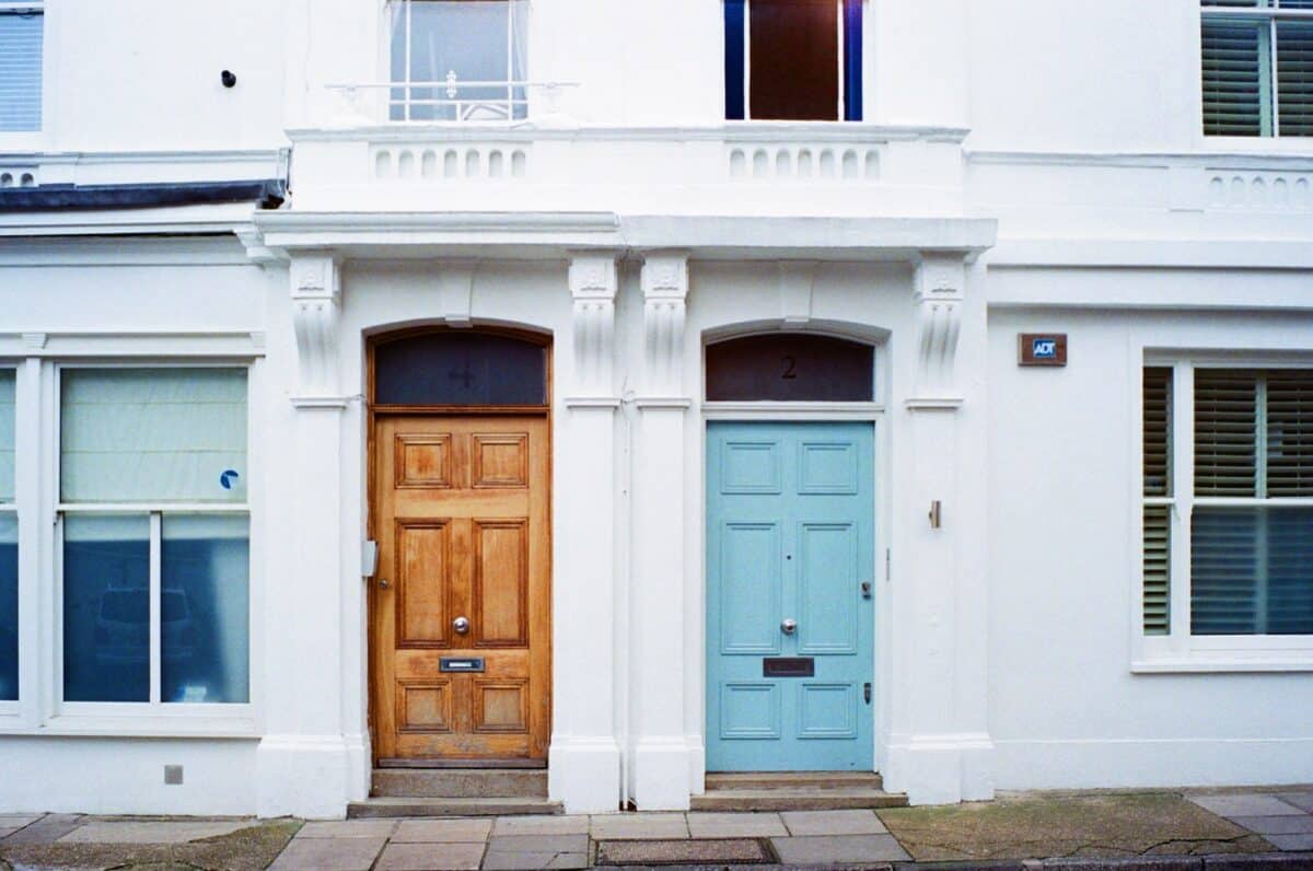 brown and blue wooden doors at the building shut close